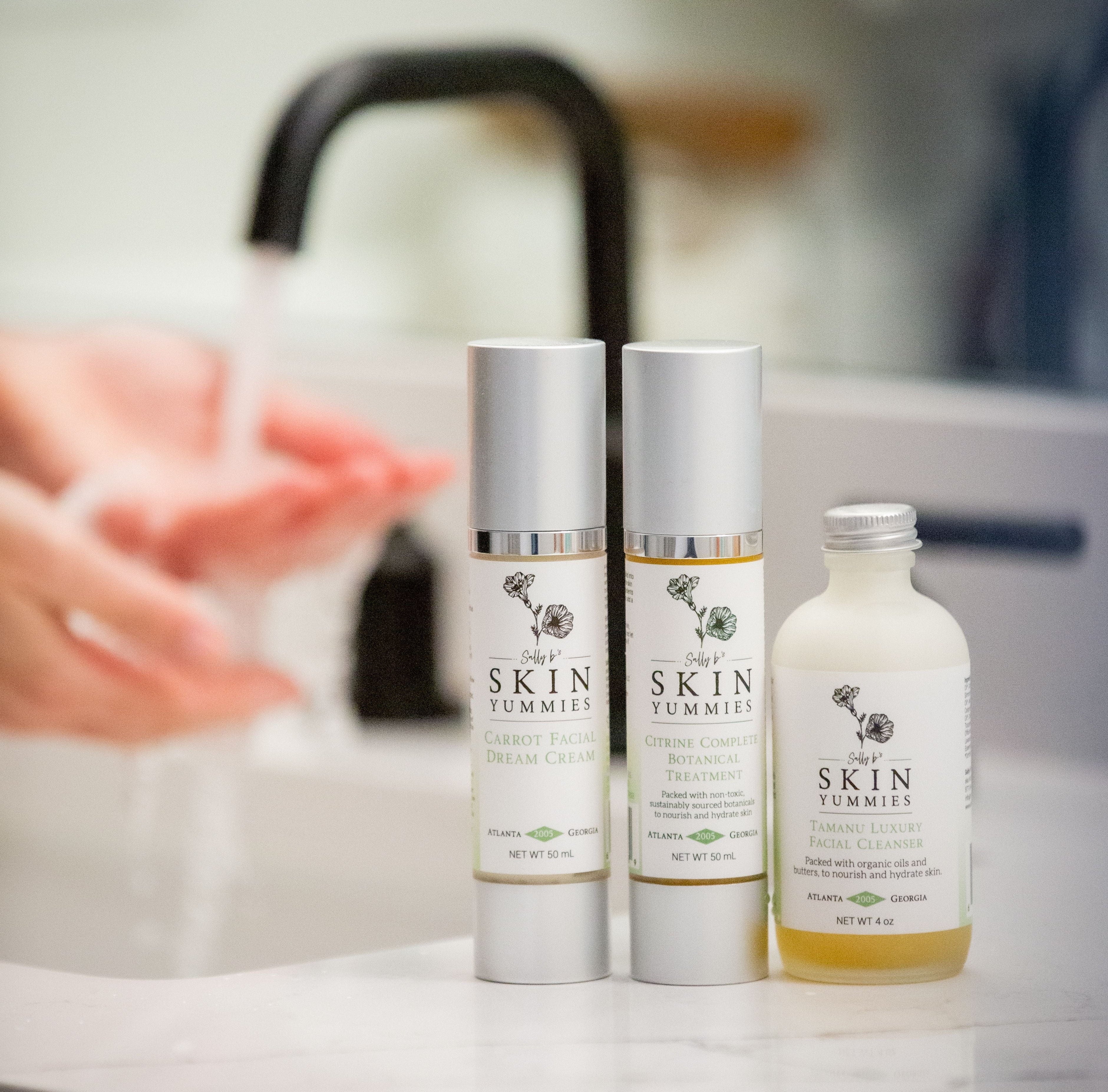 Three skincare products on a bathroom counter with a blurred background